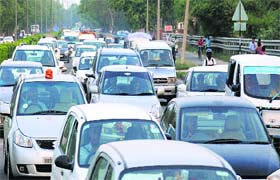 CHOC-A-BLOCK: Long queues of vehicles bring traffic to a halt at the Hallo Majra light point on the Chandigarh-Ambala Highway