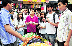 MAD volunteers convince a shopkeeper to not use polybags at the Paltan Market in Dehradun on Sunday