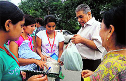 U Turn Foundation volunteers distribute cloth bags among the shoppers in Dehradun