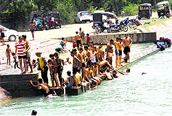 Youngsters take a dip in a canal as temperature hovers over 40 C in Hisar on Sunday