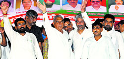 Chief Minister Bhupinder Singh Hooda waves at the crowd during a rally in Assandh on Sunday