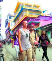 Foreign tourists enjoy a walk in McLeodganj on Sunday.