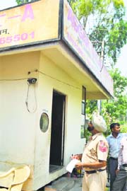 A policeman inspects a CCTV camera installed at the site where the worker was robbed at Aggar Nagar on the Ludhiana-Ferozepur road in Ludhiana on Saturday night.