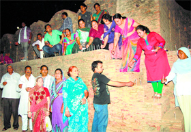 Social activists light candles at Bhatner Fort in Hanumangarh on Saturday.