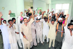 Patients protest at the Civil Hospital in Bathinda on Monday. Tribune photo