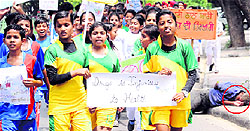 Unmindful of a drug addict (encircled) lying on the roadside, students of Government Senior Secondary School, Phase 3B1, hold a rally to create awareness against drugs in Mohali on Monday