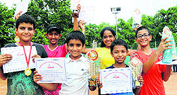 Winners and runners-up show their trophies after the Tricity Tennis Championship at Shemrock School, Sector 69, Mohali, on Monday
