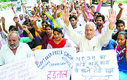 Members of the Government Fair Price Shop Welfare Association protest at the Food and Supply Office in Sector 17, Chandigarh, on Monday