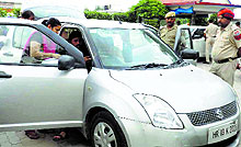 A forensic team examines jewellery showroom owner Aashi Khannas car that was abandoned by the robbers