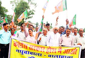 BJP workers protest at Nathuwawala area in Dehradun on Monday.