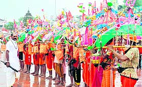MATTER OF FAITH: Kanwariyas with their decorated Kanwars hold prayers before moving towards Brahamkund in Haridwar on Monday to fetch Ganga jal.