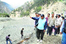 Jagat Singh Negi inspects the flooded river in Kinnaur district