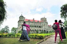 Tourists enjoy a cloudy weather at the Indian Institute of Advance Study in Shimla on Monday