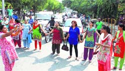 NCLP staff block traffic in front of the DC office in Jalandhar on Monday. Photo: Sarabjit Singh