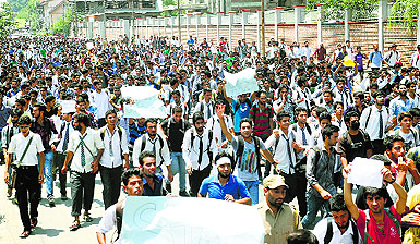 College students hold placards and shout anti-Israeli slogans during a protest against Israeli military operations in Gaza, in Srinagar on Monday