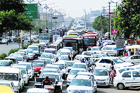 Vehicles stuck in a jam during a protest outside the Atam Park police post in Ludhiana on Monday.
