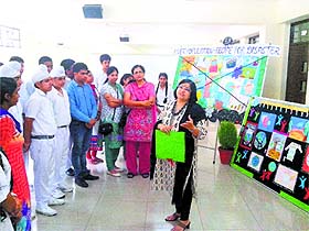 children listen to a presentation on World Population Day