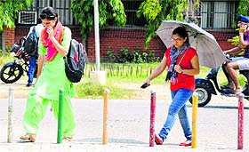 Students of Punjab Agricultural University head home on a hot and humid Monday.