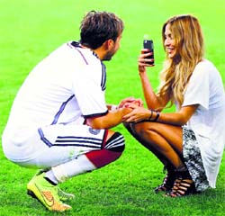 Mario Gotze has his picture taken by model girlfriend Ann-Kathrin Brommel after Germany won.