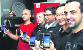 Manu Kumar Jain, head of India operations, Xiaomi Corporation, Michael Adnani, vice-president, Flipkart, Sachin Bansal, Flipkart CEO, Bin Lin, president, Xiaomi Corporation, and Hugo Barra, VP, Xiaomi Global, pose with Mi smartphones by Xiaomi at their launch in New Delhi on Tuesday. Xiaomi has partnered with Flipkart to sell its smartphones in India.