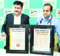 Haresh Dahyalal Trivedi (left) and Dr Manoj Majhi show the NABH accreditation certificate awarded to Max Hospital in Bathinda on Tuesday.