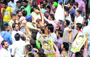 SOPU and ABVP supporters raise slogans in front of each other as the police try to control the situation at Panjab University in Chandigarh on Tuesday. 
