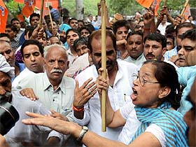 BJP activists protest against the power crisis outside the BSES office in New Delhi on Tuesday.
