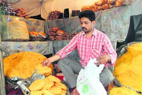 FEEDING THE FAITHFUL: A shopkeeper selling Ramadan food on Gandhi Road in Dehradun on Tuesday