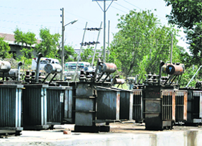 Burnt transformers lie at the Central Transformer Repair Workshop at Narwal in Jammu. 