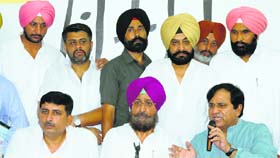 (From right below) Shakeel Ahmed, AICC general secretary, PPCC president Partap Singh Bajwa and Harish Chaudhary, AICC secretary, address the media at Punjab Congress Bhawan in Chandigarh on Tuesday.