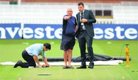 Lords groundsman Mick Hunt (centre) talks to MCC Chief Executive Derek Brewer (right) as ECB pitch consultant Chris Wood inspects the pitch at Lords in London on Tuesday.