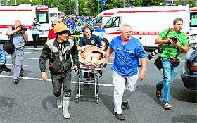 Rescuers and paramedics evacuate passengers injured after the metro derailed in Moscow on Tuesday.