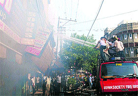 Firemen try to douse the fire that engulfed a building in the Hall Bazaar in Amritsar on Wednsday.
