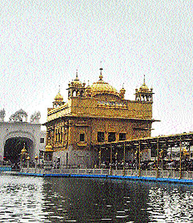 Dark clouds hover over the Golden Temple bringing down the temperature in Amritsar on Wednesday. 