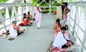 Sadhus and unknown migrants (right) who have made the railway station their permanent home in Bathinda.
