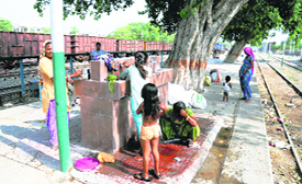 Sadhus and unknown migrants (right) who have made the railway station their permanent home in Bathinda. 