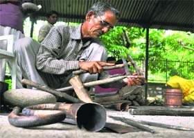 Award-winning craftman Dulab Ram Tamta makes a musical instrument Nagfani during a craft exhibition at the Anthropology Survey of India in Dehradun on Wednesday
