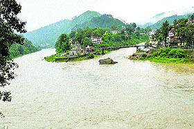 The water level of the Beas and Suketi rivulet rises beneath the Panchwaqtra temple in Mandi on Wednesday