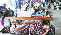 Passengers wait for buses at the general bus stand in Jammu. Tribune photo: Anand Sharma