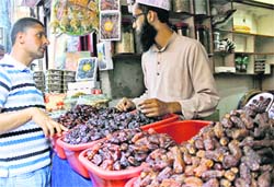 A shopkeeper sells dates during Ramadan in Srinagar on Wednesday. Photo: Yawar Kabli