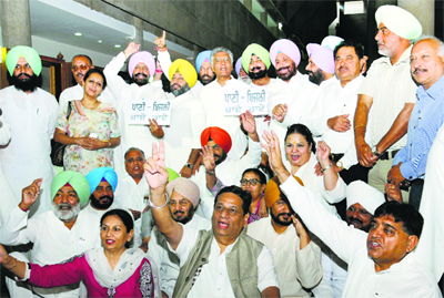 Congress MLAs protest during the Vidhan Sabha budget session in Chandigarh on Wednesday.