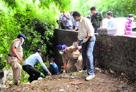 Forensic experts and policemen shift the body of Krishan Kumar, who was found dead in a nullah dividing Sectors 16 and 23 in Chandigarh on Thursday