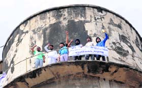 Teachers stand atop a water tank during their protest at Sohana village in Mohali on Thursday