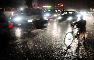 Traffic moves slow during the heavy rain in New Delhi on Thursday