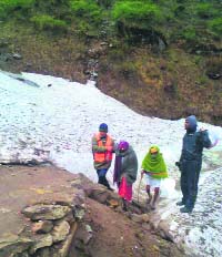 SDRF personnel help stranded pilgrims in the Gangotri region on Thursday.