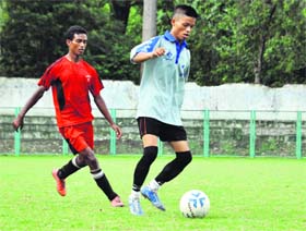 A striker dribbles the ball past a defender in a match in the Nemidas Memorial District Football League at the Pavilion Ground in Dehradun on Thursday.