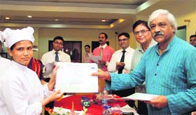 Uttarakhand Forest Minister Dinesh Agarwal hands over a certificate to a participant at the cooks training programme that concluded in IHM, Dehradun on Thursday.