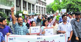 Review officers protest at the Secretriat in Dehradun on Thursday.