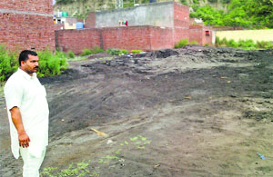 Burnt sand dumped at Prem Nagar near Ropar.
