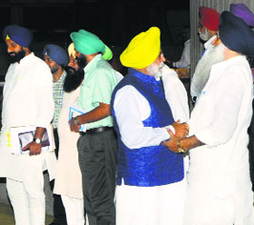 Rana Gurjeet Singh (blue jacket), Congress MLA from Kapurthala, and Virsa Singh Valtoha, Akali Dal legislator from Valtoha constituency, greet each other after the Vidhan Sabha session on Thursday. Revenue Minister Bikram Majithia (extreme left) is also seen in the picture.